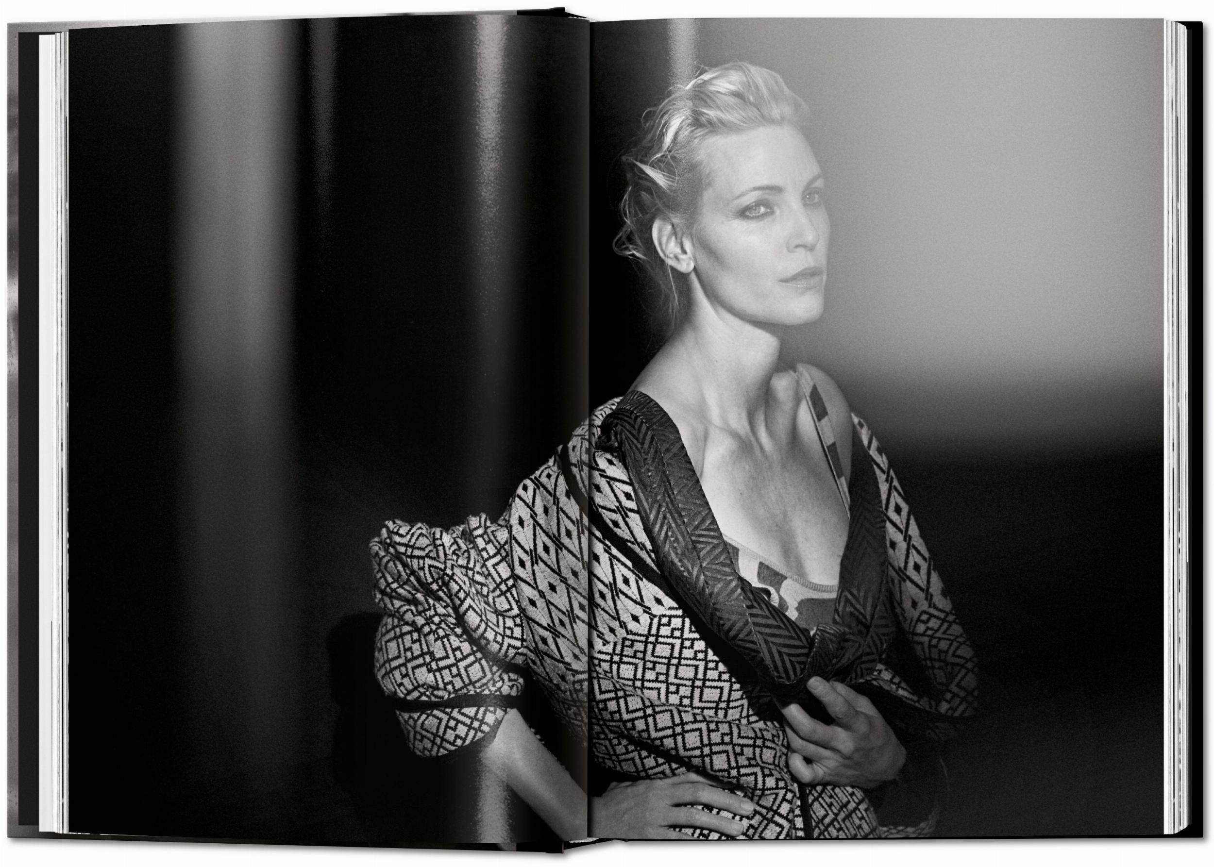 A black and white portrait of a woman in a patterned jacket featured in a photography book.